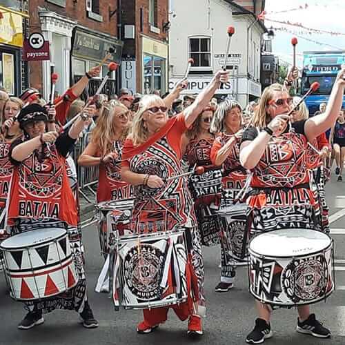 Drummers with arms in the air