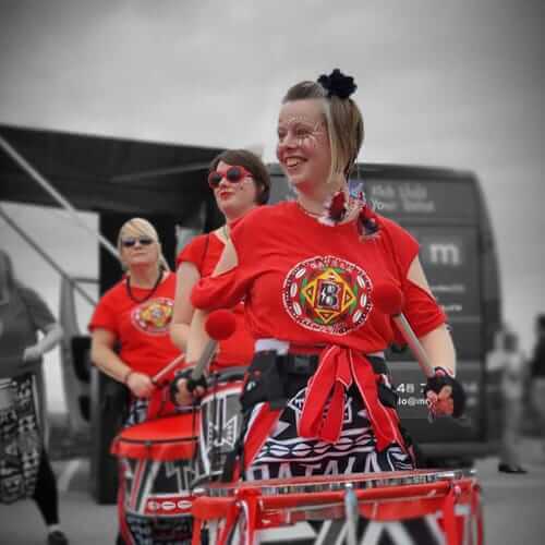 Smiling girl plays drum