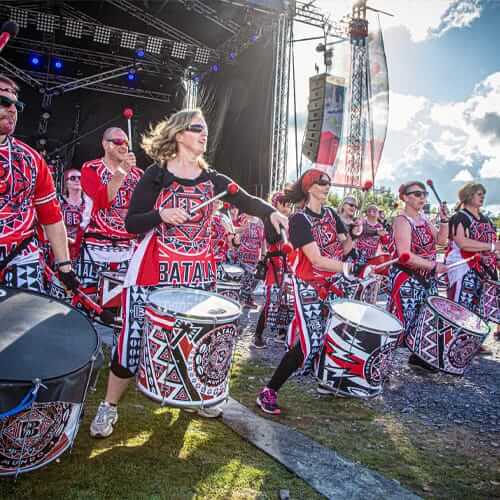 Group of drummers dancing at a festival
