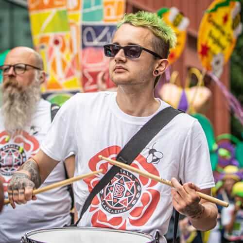 Young male drummer with green hair